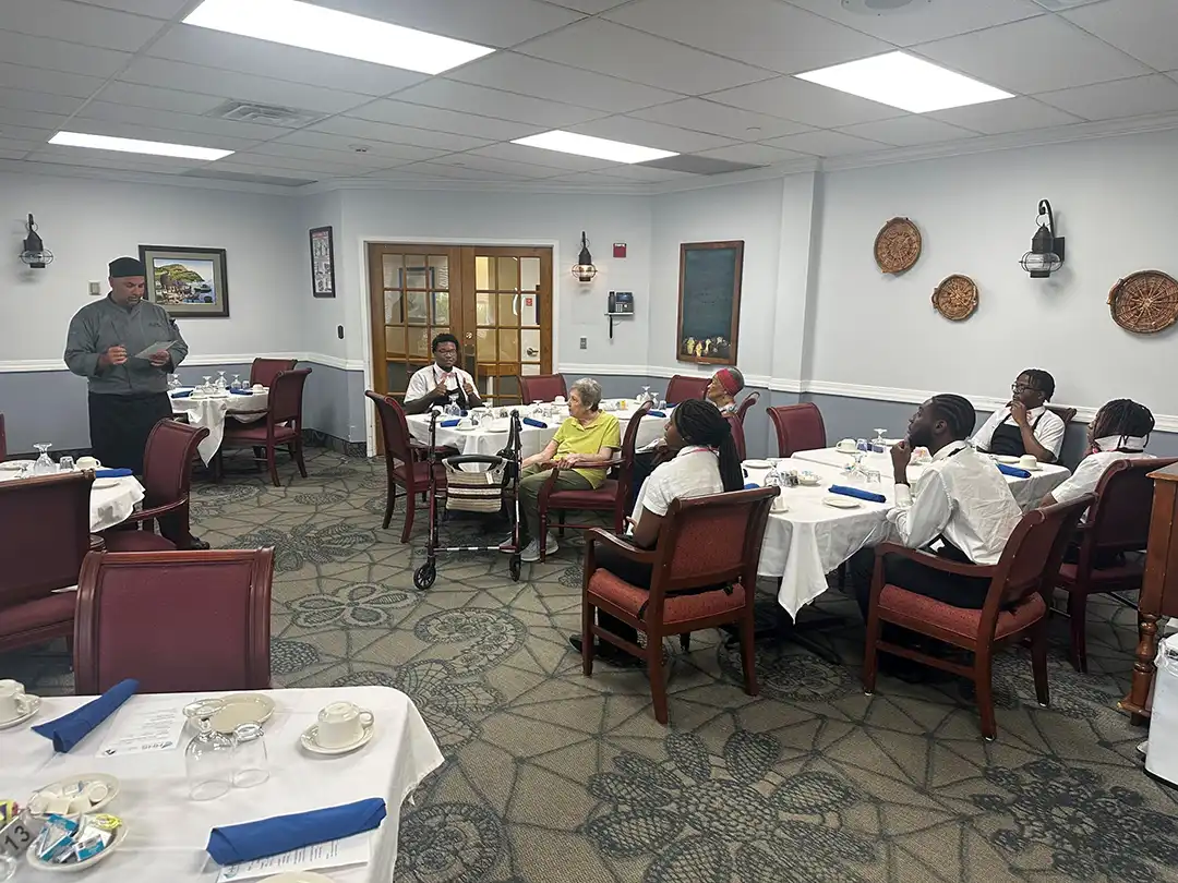 Residents and staff in the dining area at Dominican Village